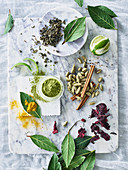 A still life with spices, lime, matcha powder and tea