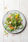 Rocket salad with proscuitto, melon and pomegranate seeds