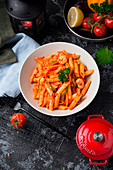 Penne pasta with tomato sauce and herbs