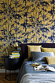 Yellow and blue bamboo-patterned wallpaper in bedroom