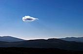 Little cloud over hills