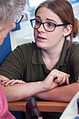 Hospital discharge officer talking to an elderly patient