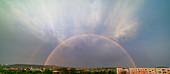 Double rainbow over city