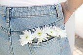 Woman with white flowers in back pocket