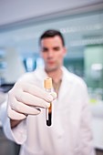 Lab assistant holding test tube