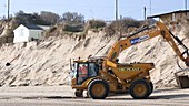 Clearing eroded beach after a storm