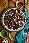 Beets carpacio with feta cheese, fresh basil, pumpkin seeds and olive oil