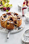 Plum and blueberry cake with cream and plum sauce