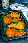 Baked pumpkin halves with olive oil and parsley