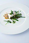 Cod with spring onions and a poached quail egg