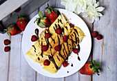 Crepes with berries and chocolate