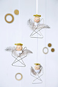 Small angel decorations made from paper clips, beads and feathers