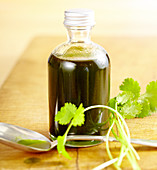 Homemade coriander oil with fresh coriander leaves