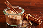 Homemade cinnamon sugar in a mason jar with cinnamon sticks