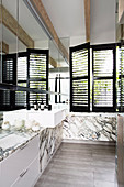 Wash basin in elegant bathroom with marble covering