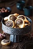 Puff pastry swirls filled with tapenade or black olive spread and parmesan cheese