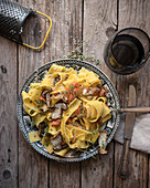 Plate with prepared pappardelle with pumpkin and boletus
