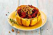 A pumpkin filled with beetroot, cashew and vegan cheese
