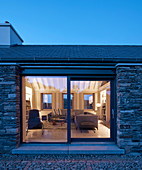 View of illuminated living room seen through terrace doors