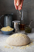 Sprinkling Cheese onto Bread dough