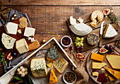 Selection of cheeses with fruit, crackers, herbs and chutney