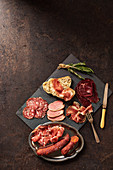 Selection of cured meats with bread and rosemary