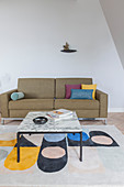 Coffee table with marble top on brightly patterned rug in front of sofa