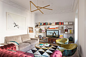 Various upholstered furnishings and TV on shelving in living room