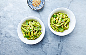 Penne pasta with kale and cashew nut pesto and toasted pine nuts