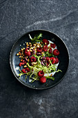 Frisee lettuce with raspberries, olives, sheep's yoghurt and pine nuts