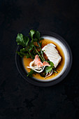 Cod fillet with udon noodles and rocket in a miso stock