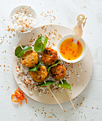 Crab meatballs with kaffir lime leaves, an orange and chilli sauce and aromatic sesame seed rice