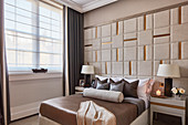 Elaborately upholstered wall in elegant bedroom
