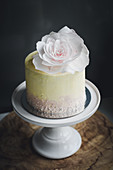 A restive mini cake decorated with a rose