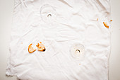 Leftover bread crisps and empty wine glasses on a white cloth
