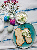 Sliced bread plait with cream cheese and cress on an Easter table