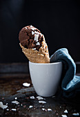 Vegan chocolate and coconut ice cream in a cone