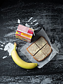 A sandwich, a banana and juice for a break