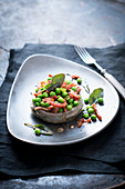 Stuffed artichokes with peas, ham and sage