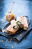 Filo pastry rolls stuffed with wild herbs and served with orange compote