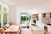 White kitchen with dining area in open living room