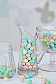 Jars of chocolate Easter egg candy on a table with a bunny shaped banner