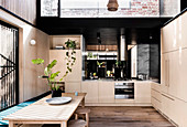 Modern kitchen with light wooden fronts and skylight