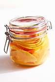 Papaya preserved in rum and liqueur with honey in a jar