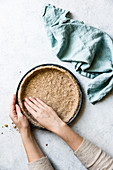 Hands preparing a pie base with alternative healthy flours