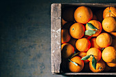 Fresh oranges in an old wooden box