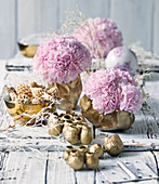 Pink carnations in golden bowls