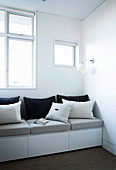 Black and gray pillows on a sideboard as a bench