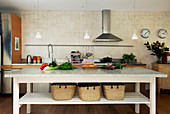 Long table with storage baskets as a kitchen island