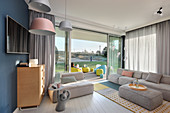 Modern living room in pastel shades with access to terrace and garden